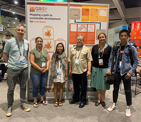 CIESIN staff members exhibiting a display graphic describing the goals of the GRID3 program, at the Sustainable World Showcase of the 2019 Esri User Conference.